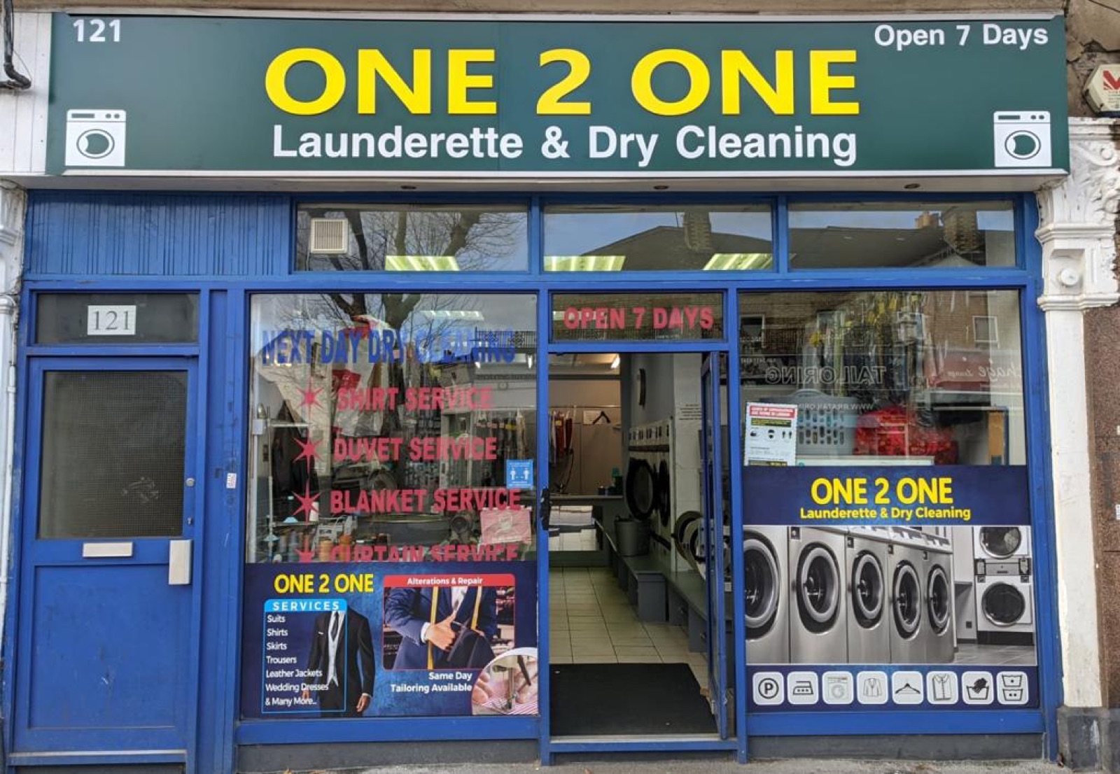 Wide view of the shop interior, counter on one side and machines on the other
